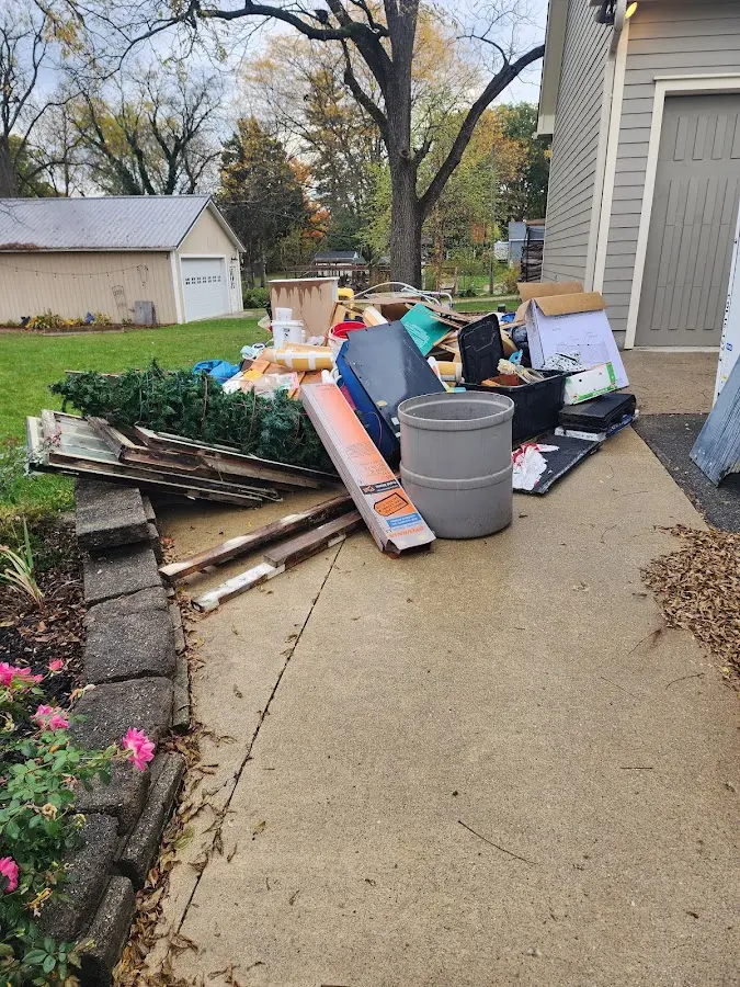 Dumpster being loaded with debris for 3 Yard Dumpster Rental in Urbana